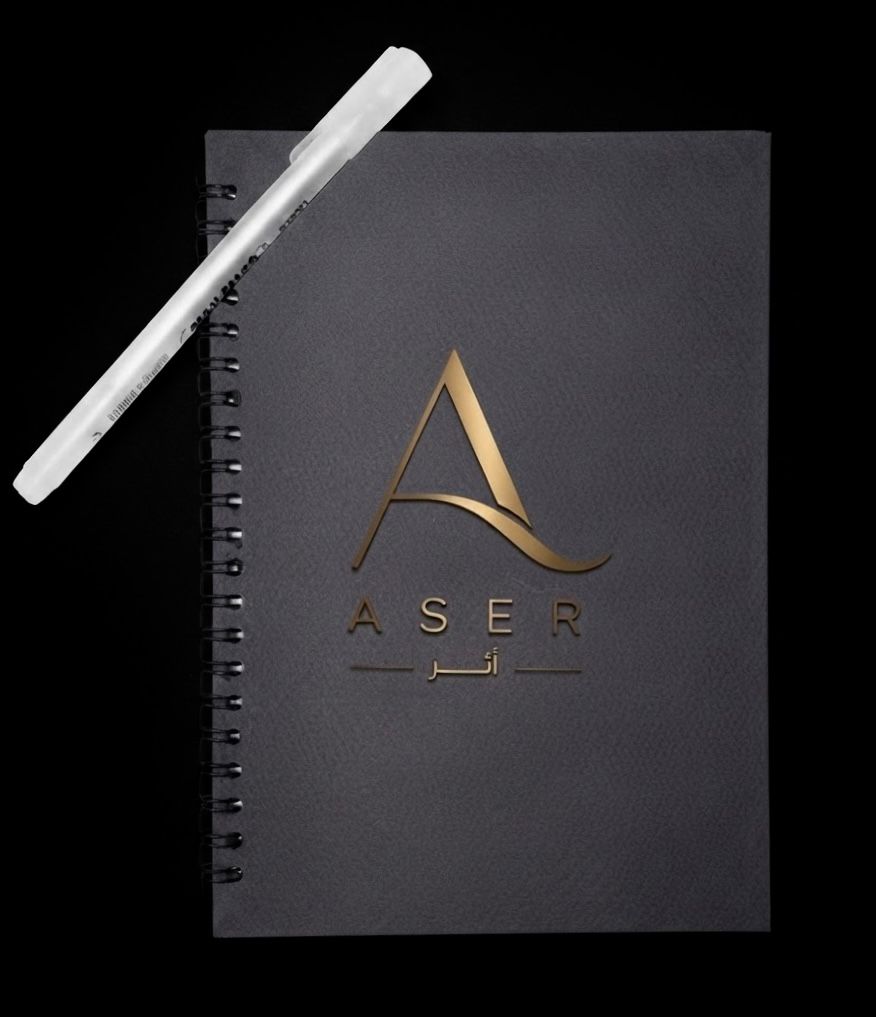 Black notebook and white pen